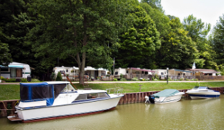 lake with boats and trailers in back